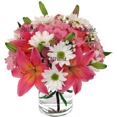 Tender and lovely combination of lilies, chrysanthemums and alstroemerias in glass cube