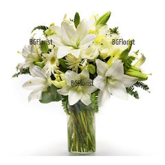 Tender bouquet of three snow-white lilies, 5 white gerberas, chrysanthemums and a lot of greenery.