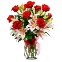 Luxuriant bouquet of a dozen red roses and white-pink lilies.