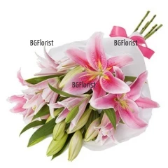 Classic bouquet of pink lilies, finished with gift wrap and a ribbon.
