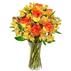Sunny, lurid bouquet of orange roses  and alstroemeria, tied with a ribbon.