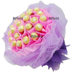 Unique gift - bouquet of luxurious Ferrero Rocher chocolates, wrapped in pink and purple papers.