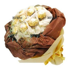 Bouquet of luxury Ferrero Rocher chocolates, wrapped in gift papers in brown hues.