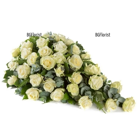 Send funeral arrangement with white roses