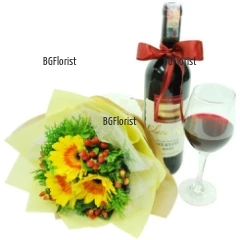 Sunny bouquet of 3 yellow gerberas and greenery, complemented with a bottle of red wine.