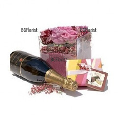 Splendid gift for the beloved one - arrangement with pink roses in glass cube, a bottle of Champagne and luxury chocolates