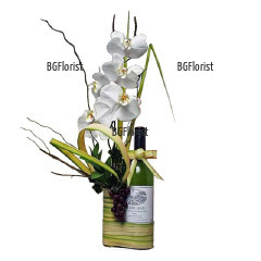 Exotic arrangement with Phalaenopsis orchid , a bottle of red wine and dry elements. Perfect gift for men.
