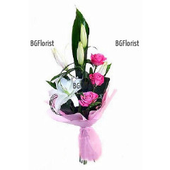 Wonderful  bouquet of three delicate pink roses and white lily, wrapped in gift paper