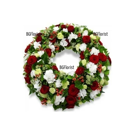 Send a funeral wreath of red roses and white flowers to Sofia.