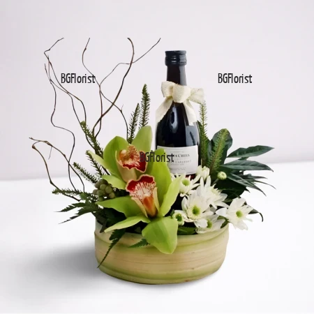 Send arrangement with orchids and wine by courier.