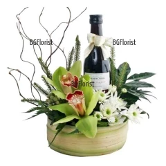 Impressive arrangement, perfect combination of flowers and a bottle of wine.