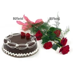 Delicious chocolate cake in combination with effective bouquet of roses and greenery.