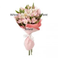 We present to you a classical bouquet of delicate pink alstroemerias, skillfully arranged with fresh greenery.