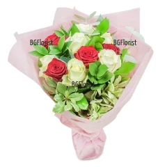A bouquet of 11 white and red roses