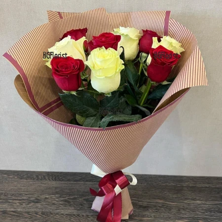 A bouquet of 11 white and red roses